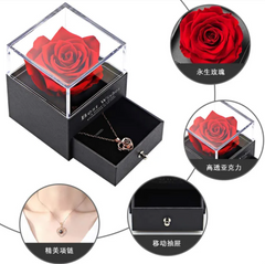 Black jewelry box with a red rose and necklace, featuring close-up details on a white background.