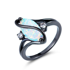 Ring with a large opal stone and smaller gemstones on a white background