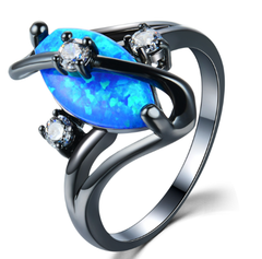 Ring with blue opal stone and black metal band on a white background