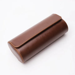 Closed brown three-slot travel watch case on a white background