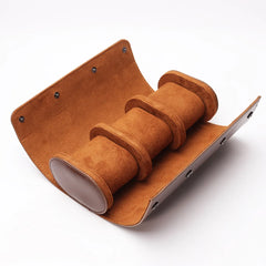 Open brown travel watch case with three padded compartments