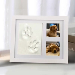White photo frame with embossed paw prints and two pictures of a dog.