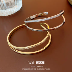 Gold- and silver-tone Celeste open cuff bracelets displayed together
