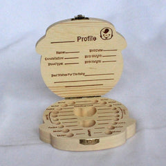 Open wooden baby keepsake box with labeled tooth compartments