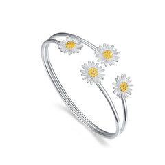 Silver bracelet with daisy flower charms on a white background