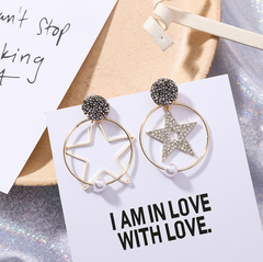 Heart-shaped rhinestone pearl drop earrings displayed on a gift card