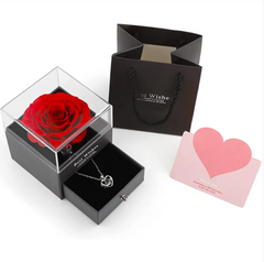 Valentine's Day gift set with red rose, necklace, and card in clear box