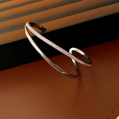 Silver-tone Celeste open cuff bracelet with a row of clear zirconia stones